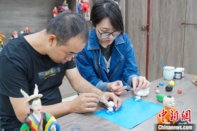 <a target='_blank'  data-cke-saved- >中新社</a>記者(右)現(xiàn)場(chǎng)體驗(yàn)面塑制作過程?！￡悹帍?qiáng) 攝